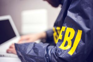 FBI agent working on his computer in office